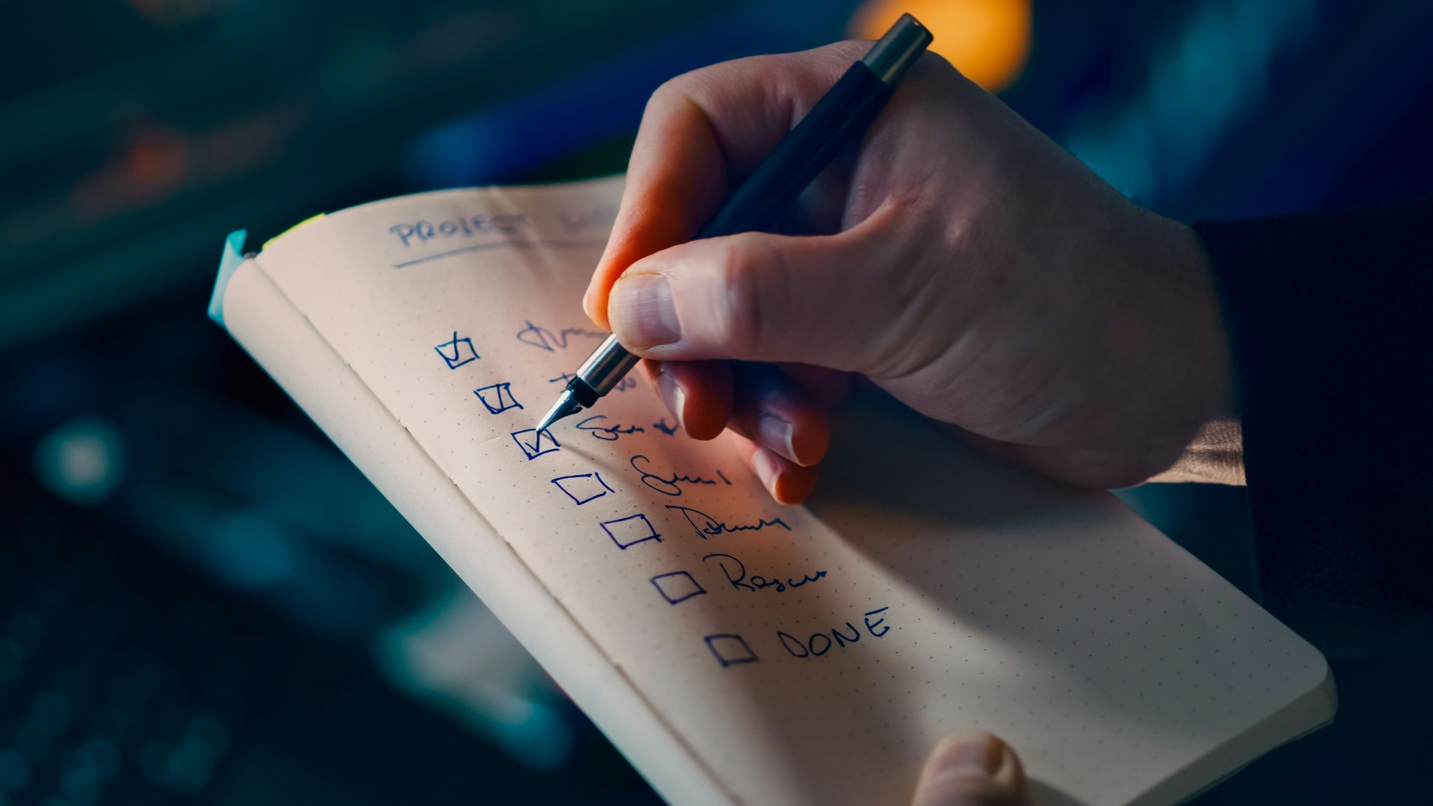 Closeup hand writing tasks notebook pen